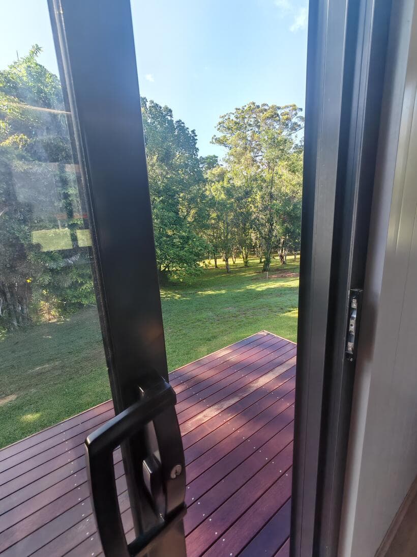 Timber and glass balustrade on an elevated deck, hillside block